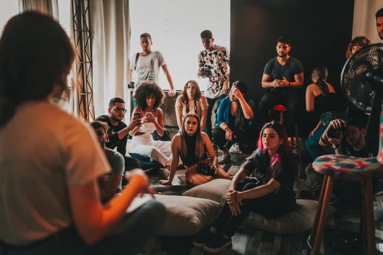 A diverse group gathered indoors in São Paulo for an engaging discussion session.